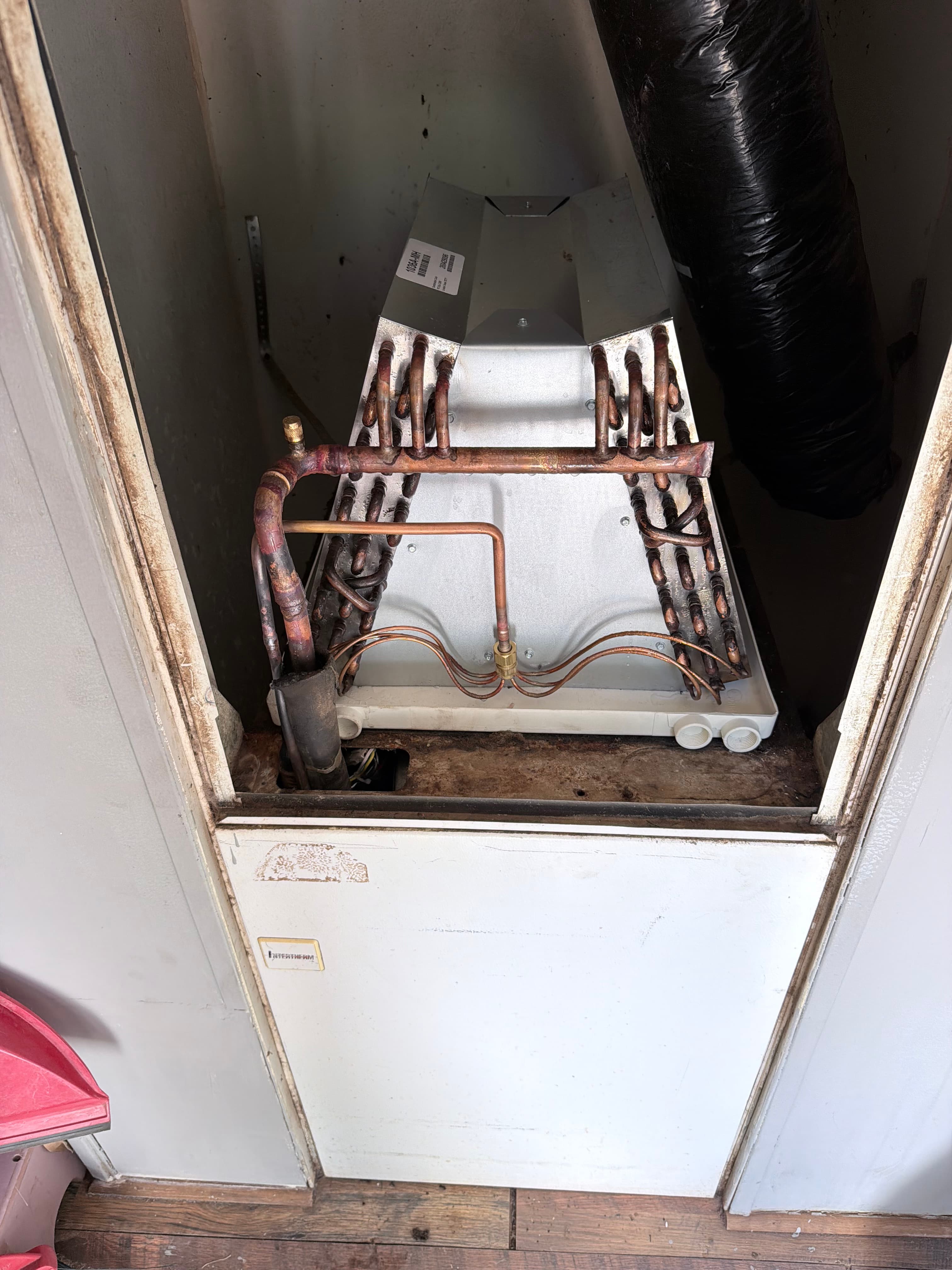 Old evaporator coil pulled out — corroded copper, needed full replacement