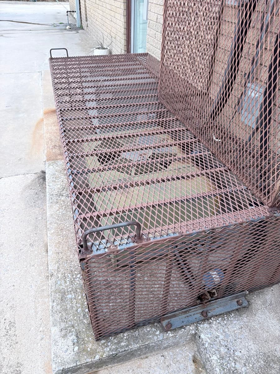 Rusted protective cage — removed before service